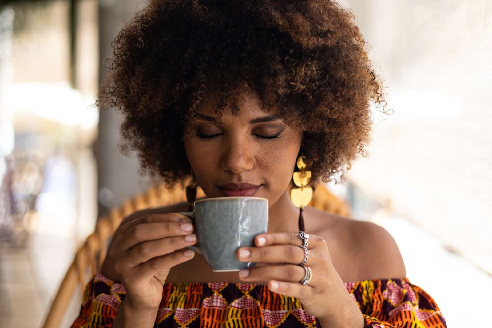 Woman enjoying a cup of My Kingdom Koffee
